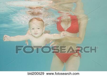 Stock Photo - Caucasian baby swimming underwater. Fotosearch