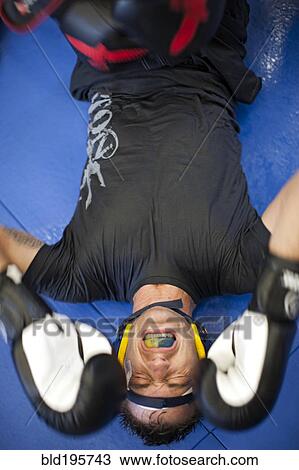 Caucasian boxer grimacing on mat View Large Photo Image Stock Image - Caucasian boxer grimacing on mat. Fotosearch