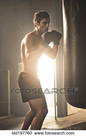 Caucasian boxer hitting punching bag View Large Photo Image Stock Image - Caucasian boxer hitting punching bag. Fotosearch
