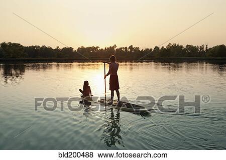 Caucasian boy and girl on paddleboard on lake View Large Photo Image Stock Photo - Caucasian boy and girl on paddleboard on lake. Fotosearch