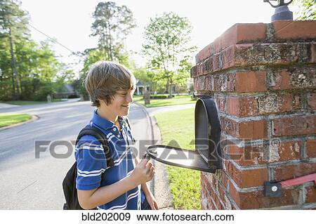 Caucasian boy opening mailbox View Large Photo Image Stock Photo - Caucasian boy opening mailbox. Fotosearch