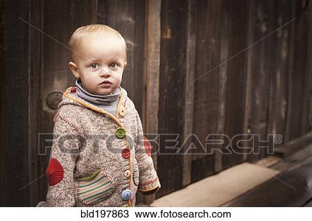 Stock Image - Caucasian boy standing outdoors. Fotosearch