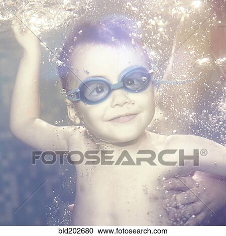 Caucasian boy swimming under water View Large Photo Image Stock Image - Caucasian boy swimming under water. Fotosearch