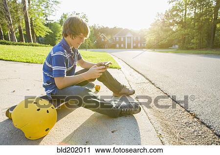 Caucasian boy text messaging on cell phone View Large Photo Image Stock Image - Caucasian boy text messaging on cell phone. Fotosearch
