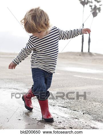 Caucasian boy walking on beach View Large Photo Image Stock Image - Caucasian boy walking on beach. Fotosearch
