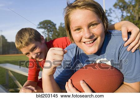Caucasian boys holding football View Large Photo Image Stock Photography - Caucasian boys holding football. Fotosearch