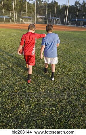Picture - Caucasian boys walking in field. Fotosearch