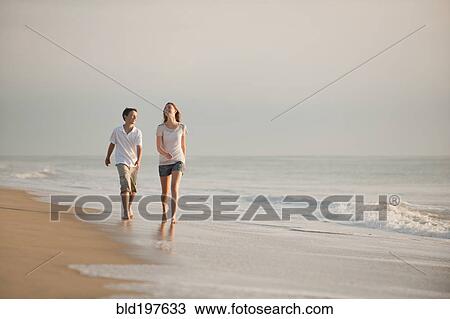 Caucasian brother and sister walking on beach View Large Photo Image Stock Image - Caucasian brother and sister walking on beach. Fotosearch