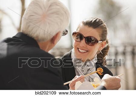 Caucasian business people eating Asian food View Large Photo Image Stock Photo - Caucasian business people eating Asian food. Fotosearch
