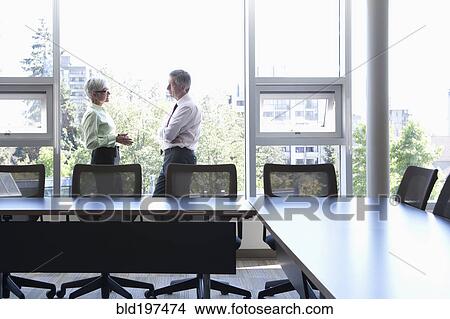 Picture - Caucasian business people talking in conference room. Fotosearch