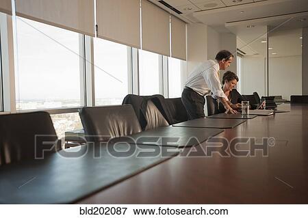 Caucasian business people working together in conference room View Large Photo Image Stock Photo - Caucasian business people working together in conference room. Fotosearch