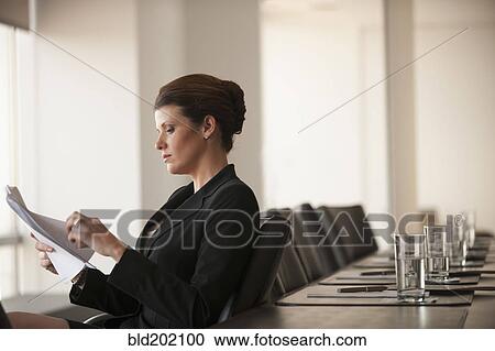 Stock Image - Caucasian business woman working in conference room. Fotosearch
