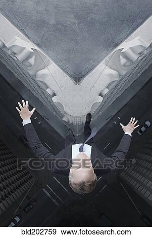 Stock Photo - Caucasian businessman jumping off skyscraper. Fotosearch