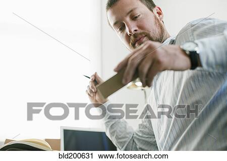 Caucasian businessman looking at prototype View Large Photo Image Stock Image - Caucasian businessman looking at prototype. Fotosearch
