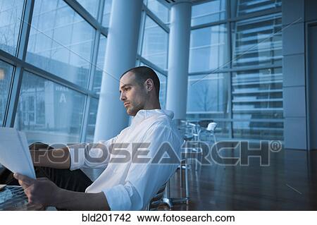 Caucasian businessman looking at paperwork View Large Photo Image Stock Image - Caucasian businessman looking at paperwork. Fotosearch