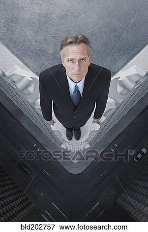 Caucasian businessman on skyscraper ledge View Large Photo Image Stock Photo - Caucasian businessman on skyscraper ledge. Fotosearch