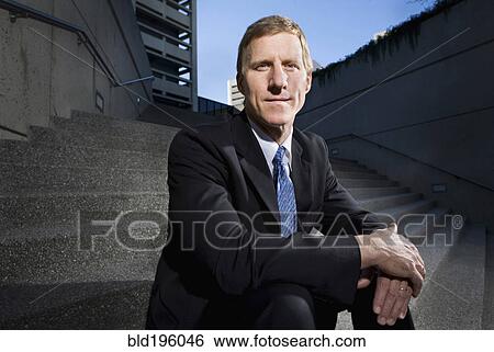 Caucasian businessman sitting on outdoor staircase View Large Photo Image Stock Photograph - Caucasian businessman sitting on outdoor staircase. Fotosearch