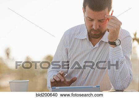 Caucasian businessman using digital tablet outdoors View Large Photo Image Stock Image - Caucasian businessman using digital tablet outdoors. Fotosearch