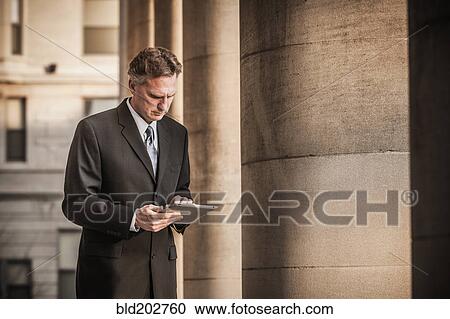 Stock Image - Caucasian businessman using tablet computer. Fotosearch