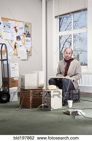 Stock Image - Caucasian businessman working in empty office. Fotosearch