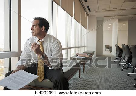 Stock Image - Caucasian businessman working in conference room. Fotosearch