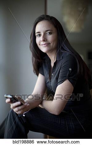 Caucasian businesswoman holding cell phone View Large Photo Image Stock Photograph - Caucasian businesswoman holding cell phone. Fotosearch