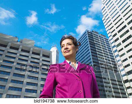 Caucasian Businesswoman standing in city View Large Photo Image Stock Photo - Caucasian Businesswoman standing in city. Fotosearch