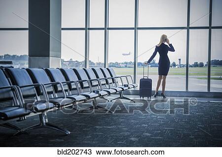 Caucasian businesswoman talking on cell phone in airport View Large Photo Image Stock Image - Caucasian businesswoman talking on cell phone in airport. Fotosearch