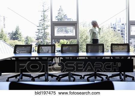 Caucasian businesswoman using cell phone in conference room View Large Photo Image Stock Photography - Caucasian businesswoman using cell phone in conference room. Fotosearch
