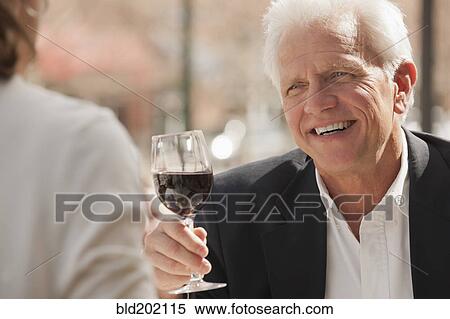 Stock Photography - Caucasian couple drinking wine. Fotosearch