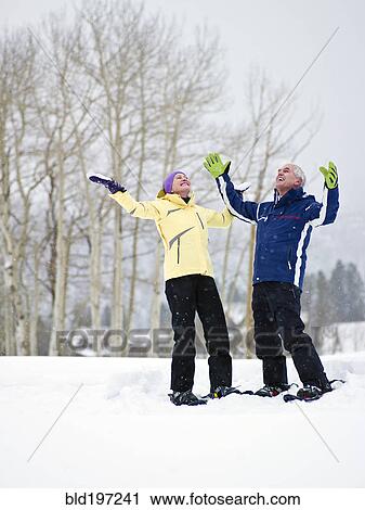 Caucasian couple enjoying snow View Large Photo Image Stock Image - Caucasian couple enjoying snow. Fotosearch