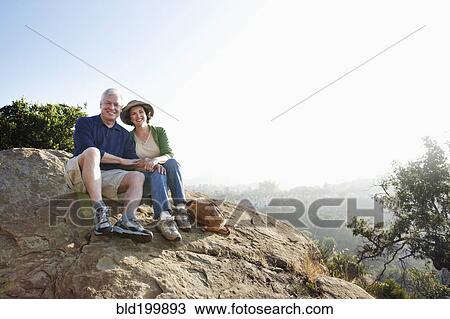 Stock Image - Caucasian couple hiking in remote area. Fotosearch