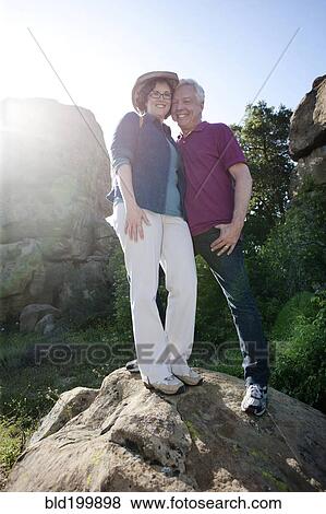Caucasian couple hiking in remote area View Large Photo Image Stock Photo - Caucasian couple hiking in remote area. Fotosearch