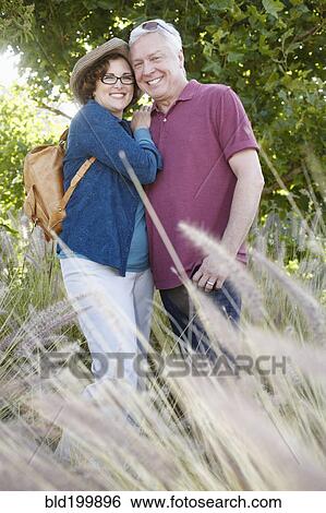 Stock Photograph - Caucasian couple hiking in remote area. Fotosearch