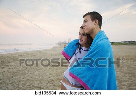 Caucasian couple hugging on beach View Large Photo Image Picture - Caucasian couple hugging on beach. Fotosearch