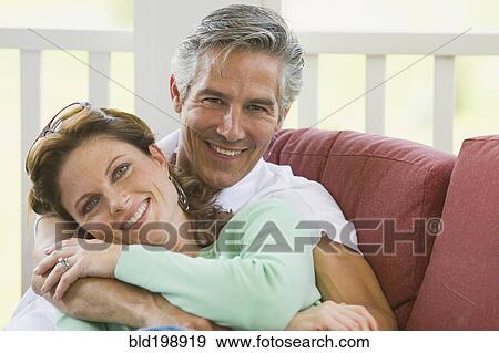 Caucasian couple hugging on porch View Large Photo Image Stock Photo - Caucasian couple hugging on porch. Fotosearch