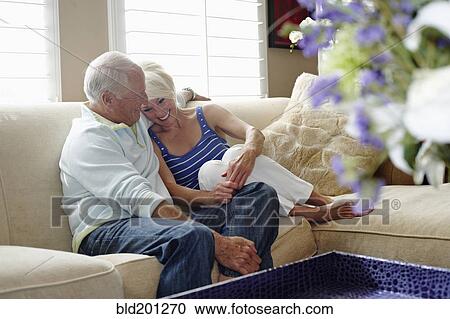 Caucasian couple hugging on sofa View Large Photo Image Stock Image - Caucasian couple hugging on sofa. Fotosearch