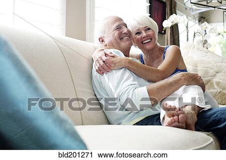 Caucasian couple hugging on sofa View Large Photo Image Stock Image - Caucasian couple hugging on sofa. Fotosearch