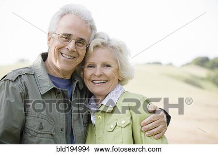 Picture - Caucasian couple hugging outdoors. Fotosearch