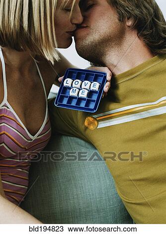Stock Image - Caucasian couple kissing. Fotosearch