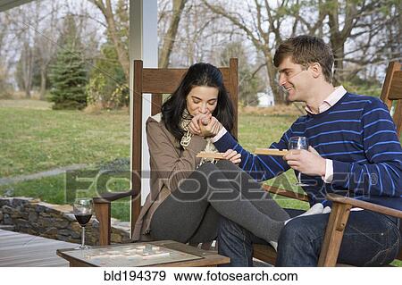 Stock Photo - Caucasian couple playing scrabble on porch. Fotosearch