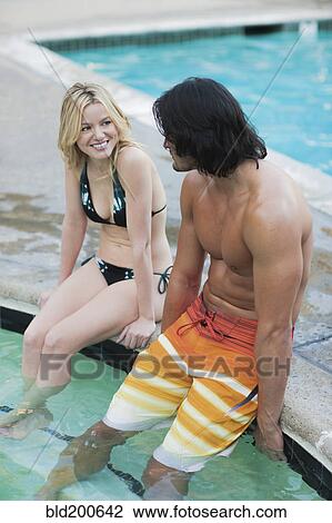 Stock Image - Caucasian couple relaxing in hot tub. Fotosearch