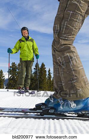 Stock Photo - Caucasian couple skiing together. Fotosearch