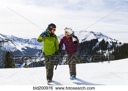 Stock Photograph - Caucasian couple skiing together. Fotosearch