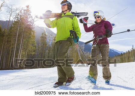 Stock Photography - Caucasian couple skiing together. Fotosearch