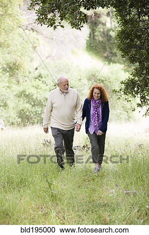 Caucasian couple walking in woods View Large Photo Image Stock Image - Caucasian couple walking in woods. Fotosearch