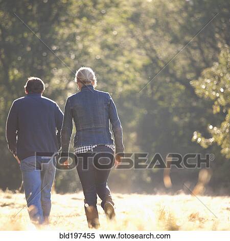 Stock Photography - Caucasian couple walking together outdoors. Fotosearch