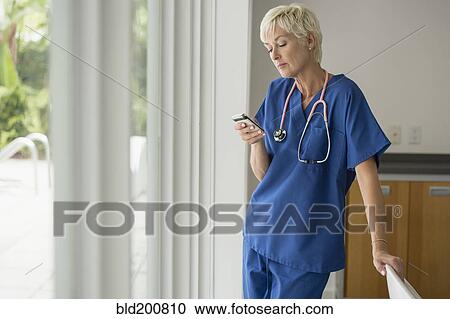 Caucasian doctor text messaging on cell phone View Large Photo Image Stock Image - Caucasian doctor text messaging on cell phone. Fotosearch