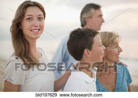 Stock Photo - Caucasian family enjoying beach. Fotosearch