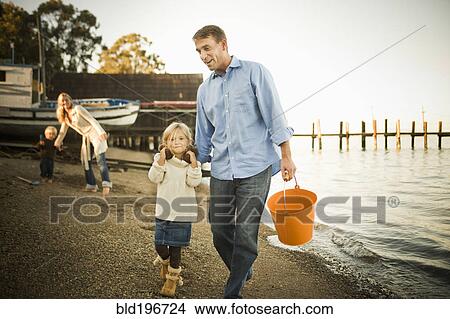 Picture - Caucasian family enjoying the beach. Fotosearch